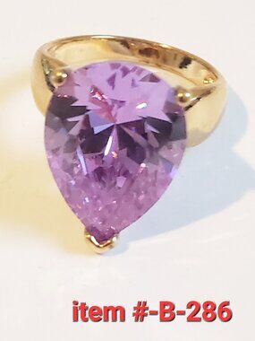 A Lite Purple Gem Stone Gold Ring, item # B -286, wt . 9 grams.